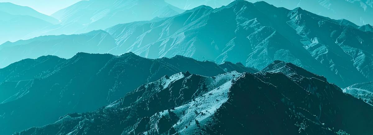 A surreal zoomed in view of layered mountain, all bathed in a soft monochromatic cyan