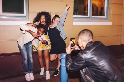 young diverse people taking pictures 